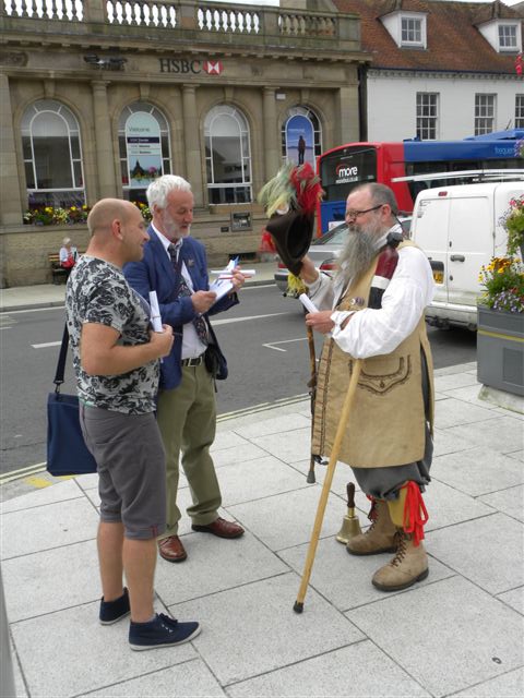 the Town Crier delivers his CRY 